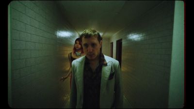 a man standing in a hallway next to a woman