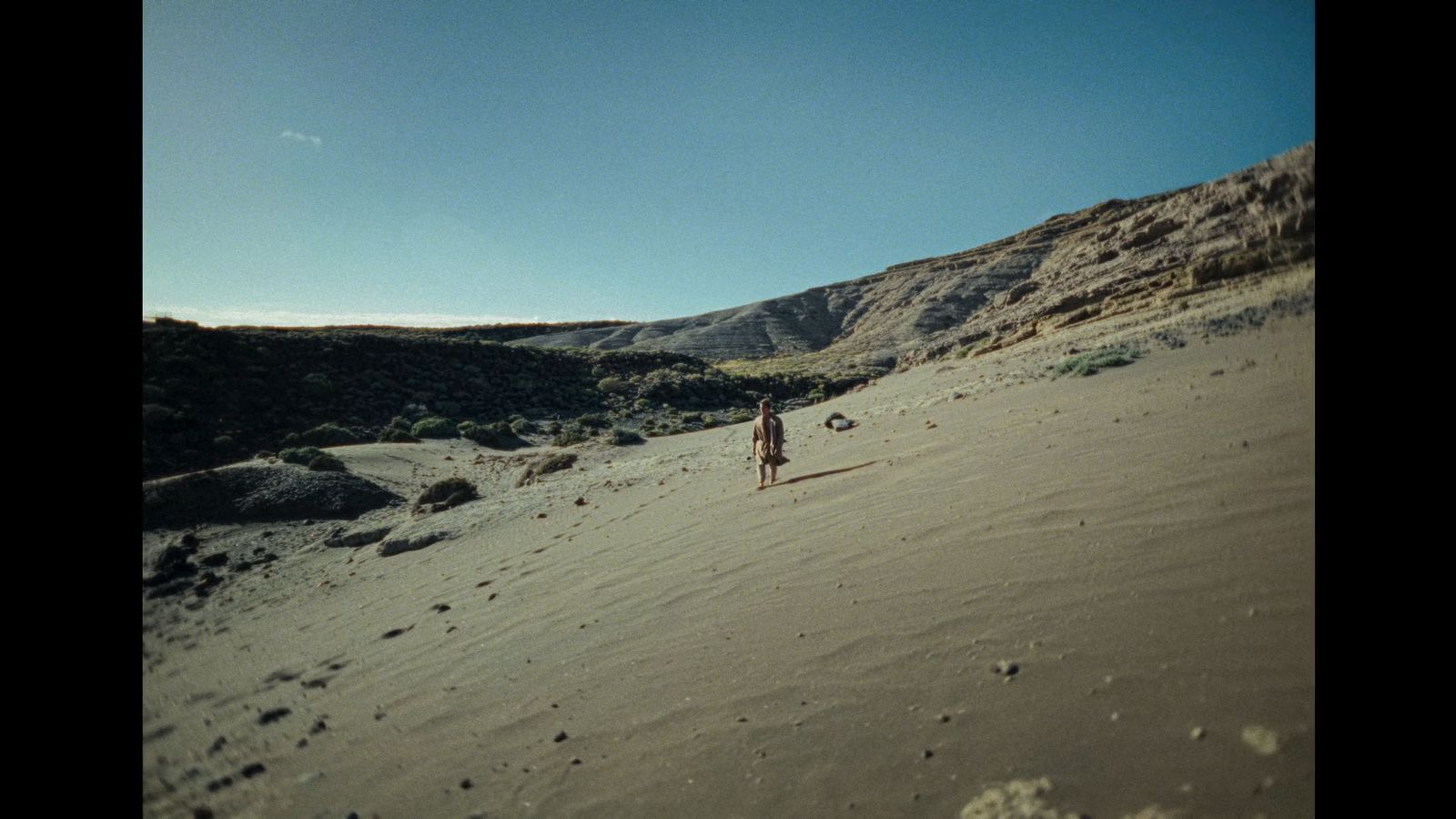 a person standing in the middle of a desert