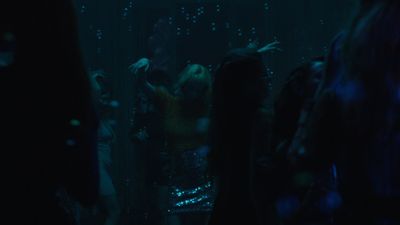 a group of people dancing in a dark room