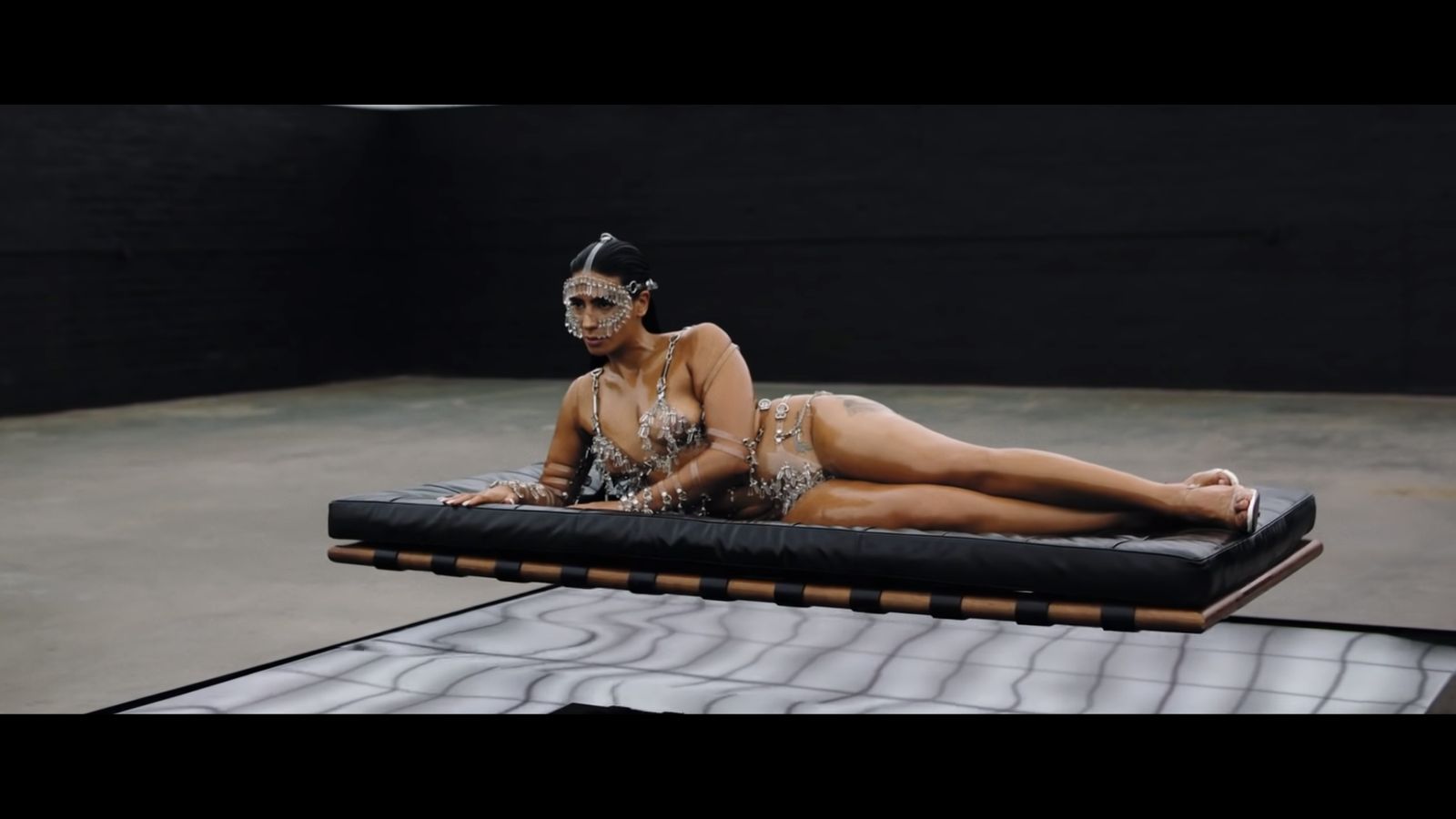a woman laying on top of a mattress on top of a floor
