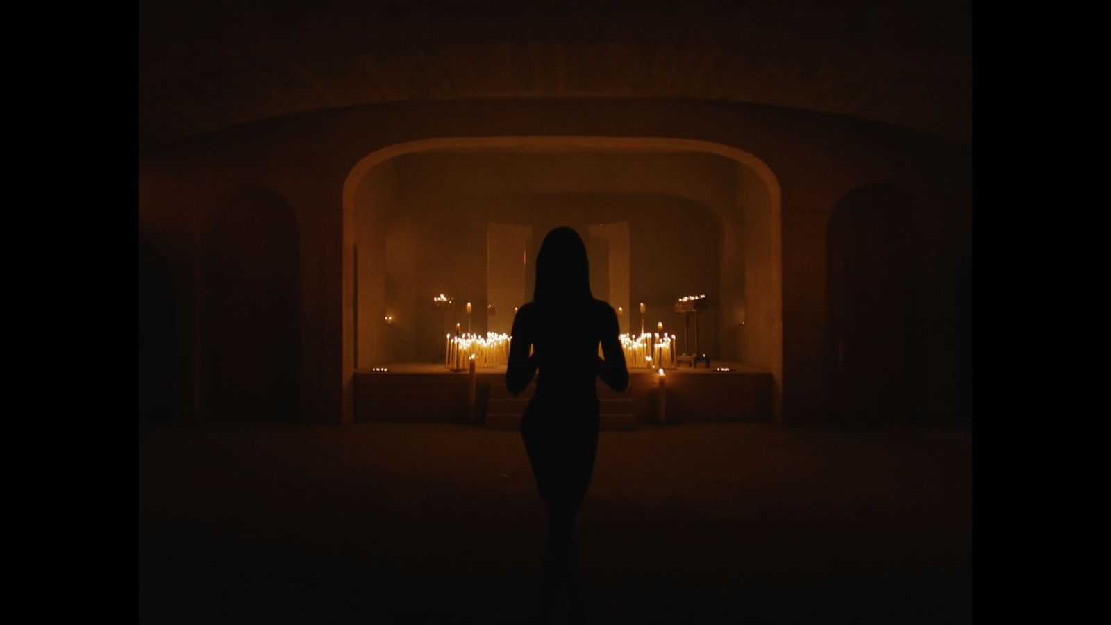 a woman standing in a dimly lit room