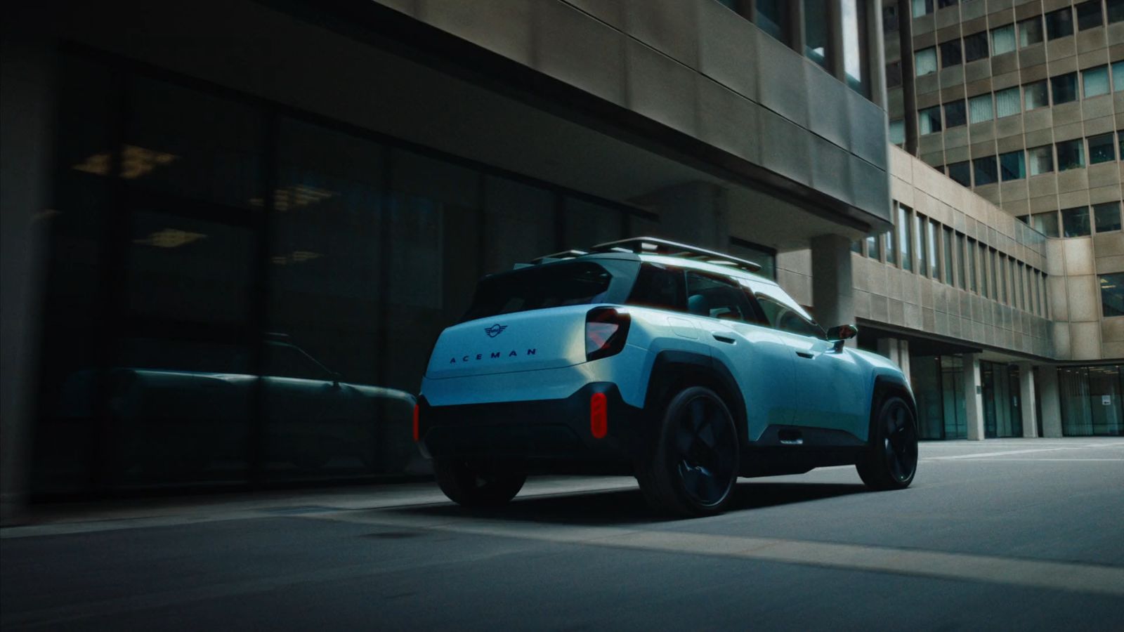 a blue suv driving down a city street