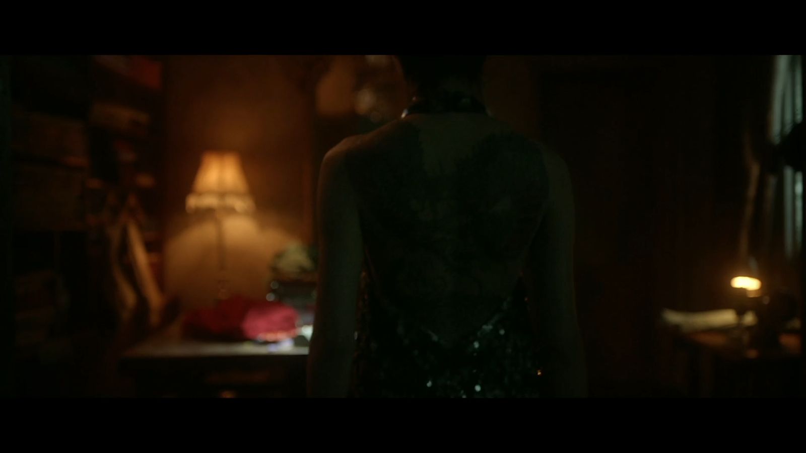 a woman standing in a dimly lit room