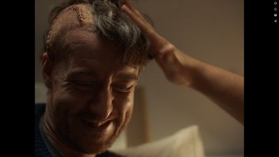 a man is smiling while getting his hair cut