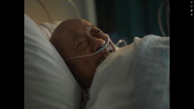 an older man laying in a hospital bed