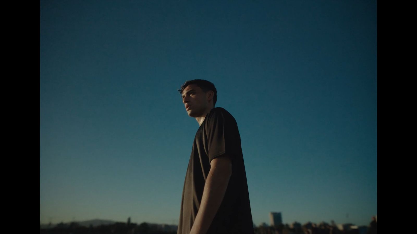 a man standing in front of a blue sky