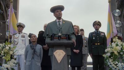 a man standing at a podium in front of a group of people