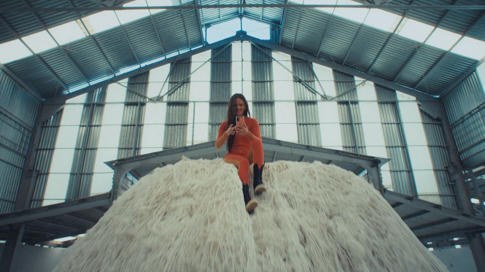 a woman sitting on top of a pile of white fur