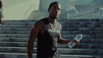 a man holding a water bottle and a skateboard