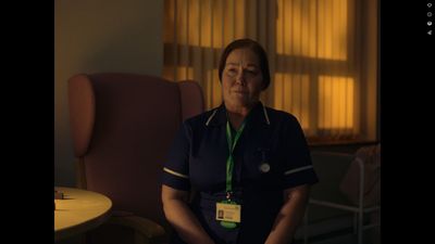 a woman in scrubs sitting in a chair