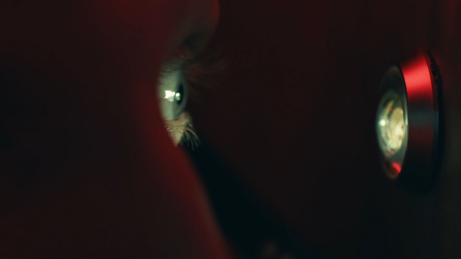 a close up of a person's face with a clock in the background