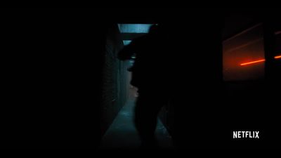 a person standing in a dark hallway at night