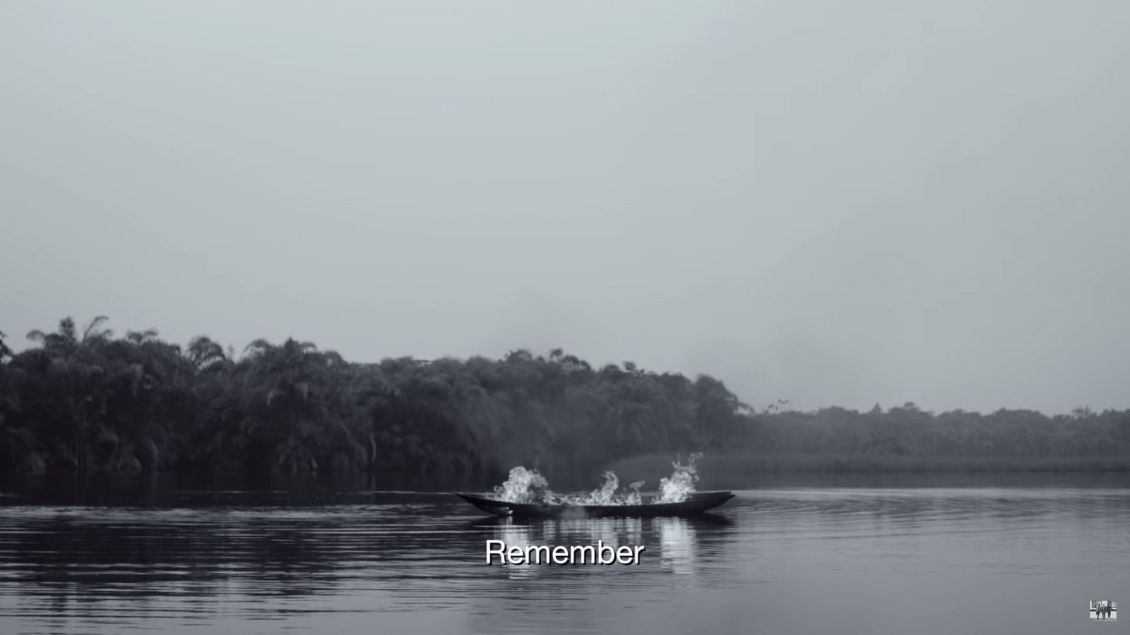 a boat on a body of water with trees in the background