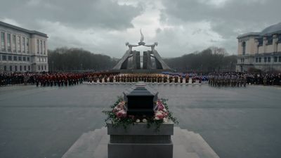 a group of people standing in front of a monument