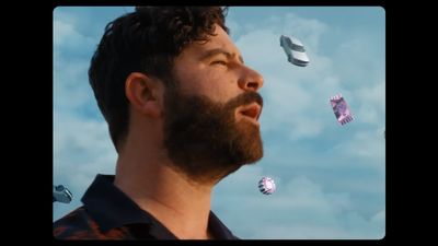 a man with a beard looking up at the sky