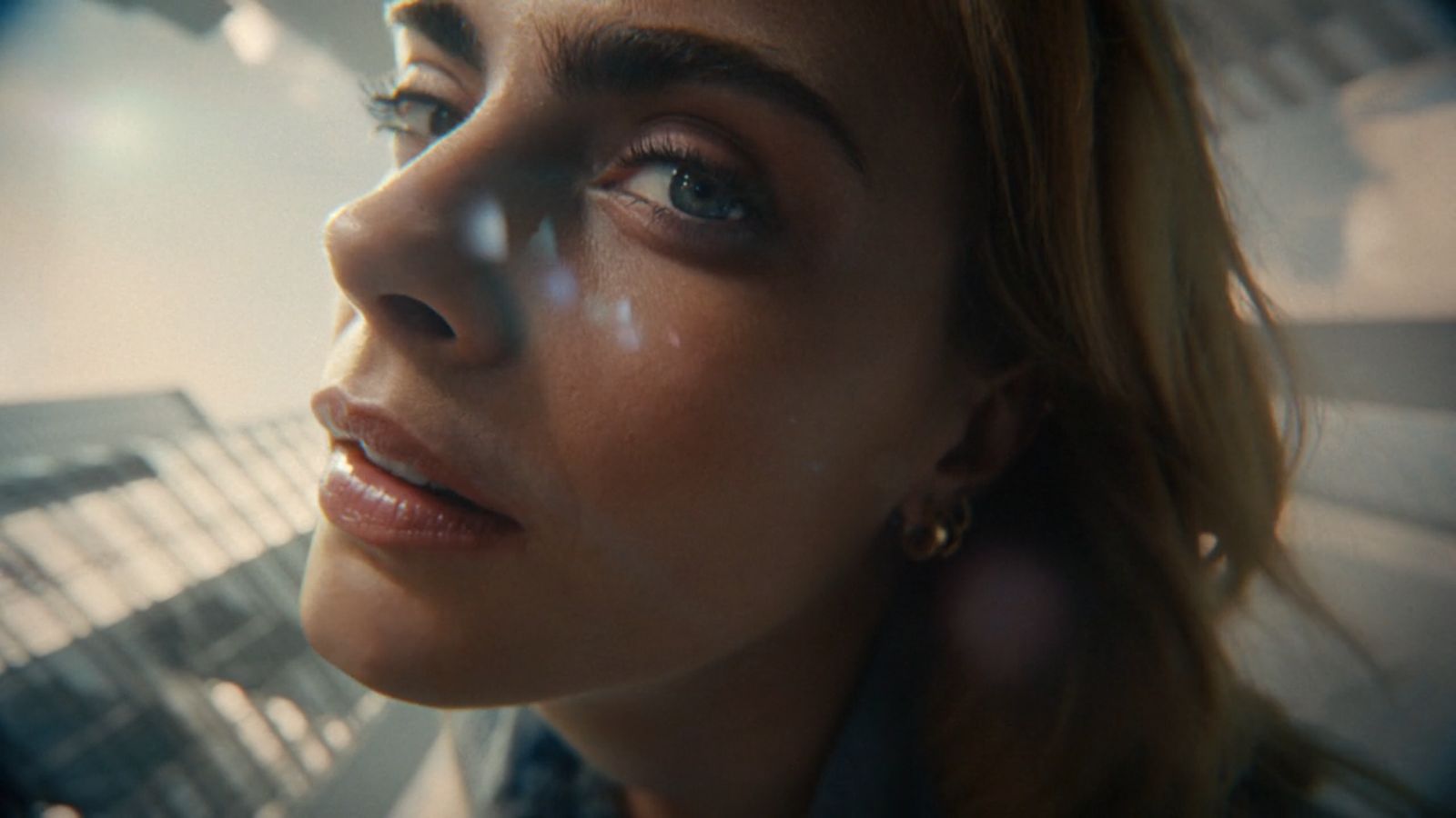 a close up of a person with a building in the background