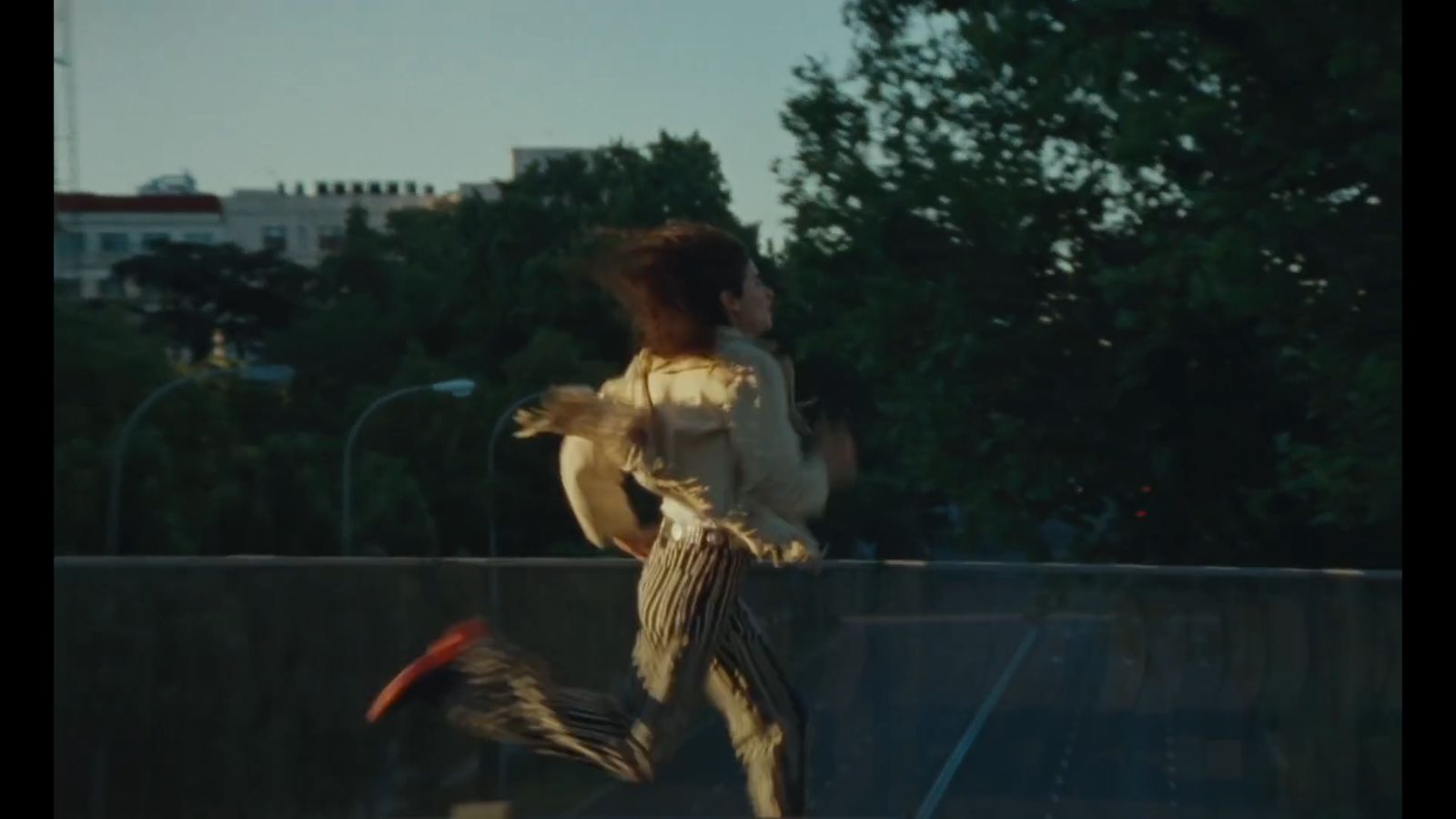 a woman is running with a bird in her hand