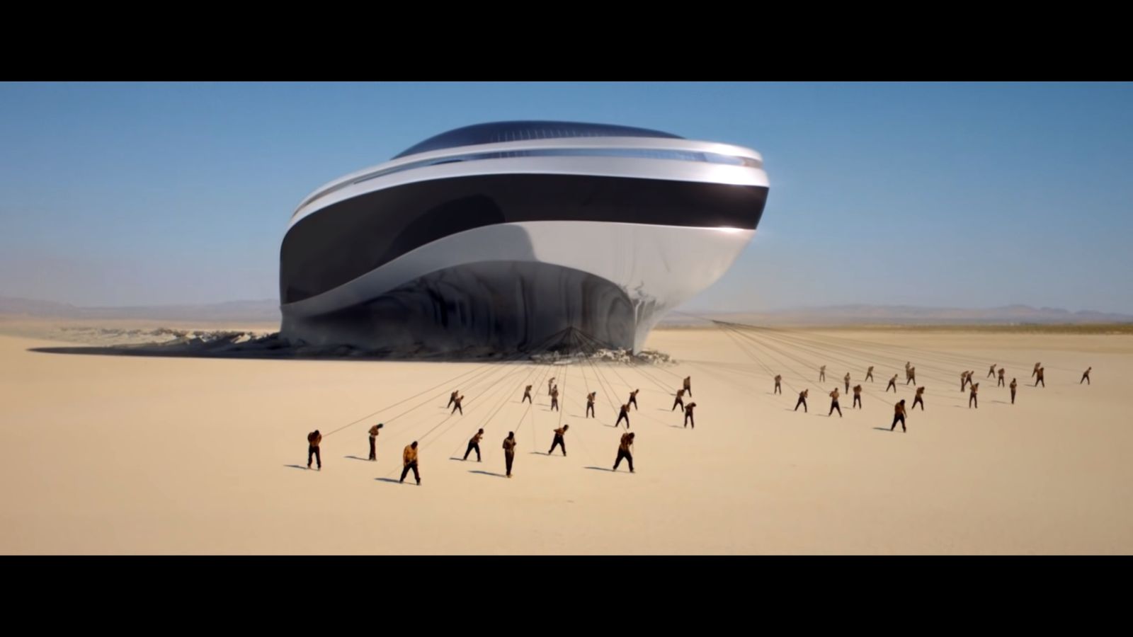 a group of people walking across a sandy field