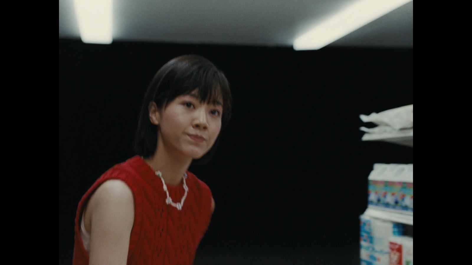 a woman in a red dress standing in a room