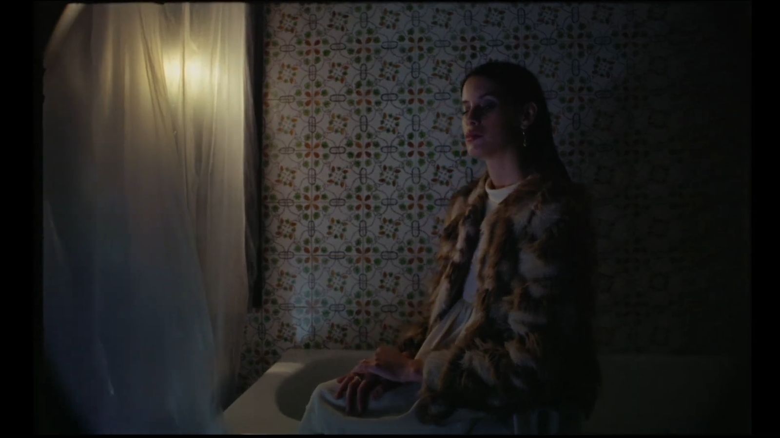 a woman sitting on a toilet in a bathroom