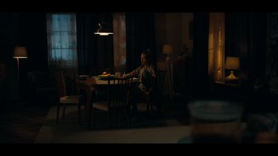 a man sitting at a table in a dark room