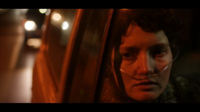 a man looking out of a car window at night