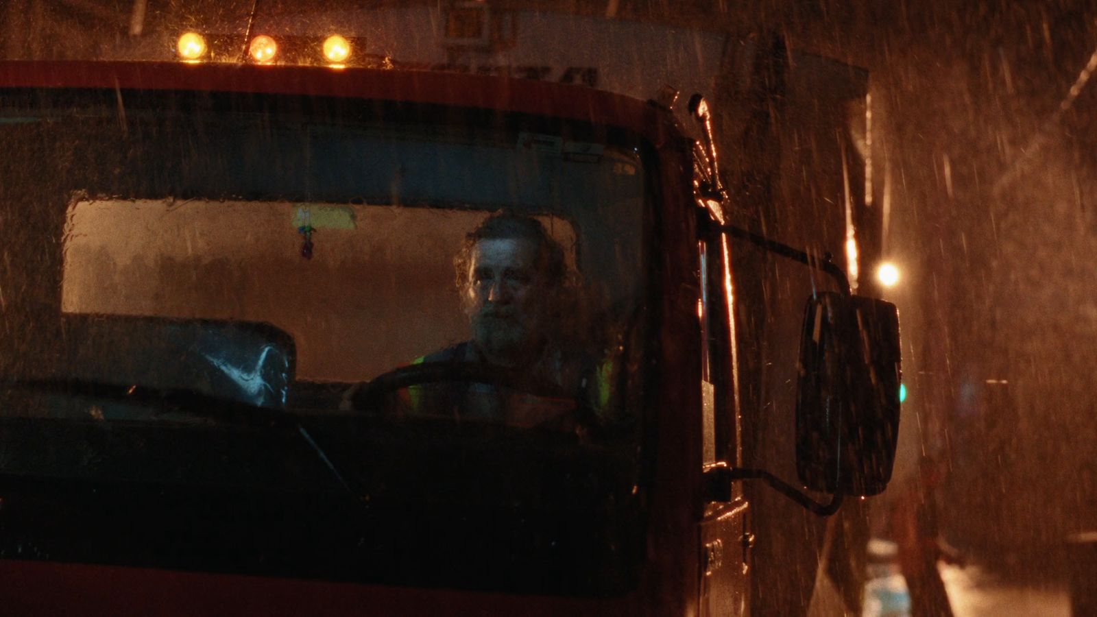 a man driving a truck in the rain