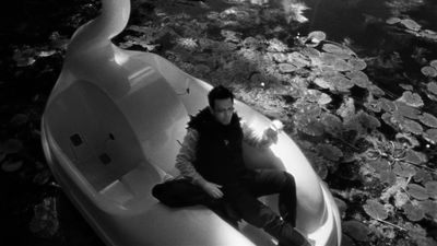 a man sitting on a boat in the water