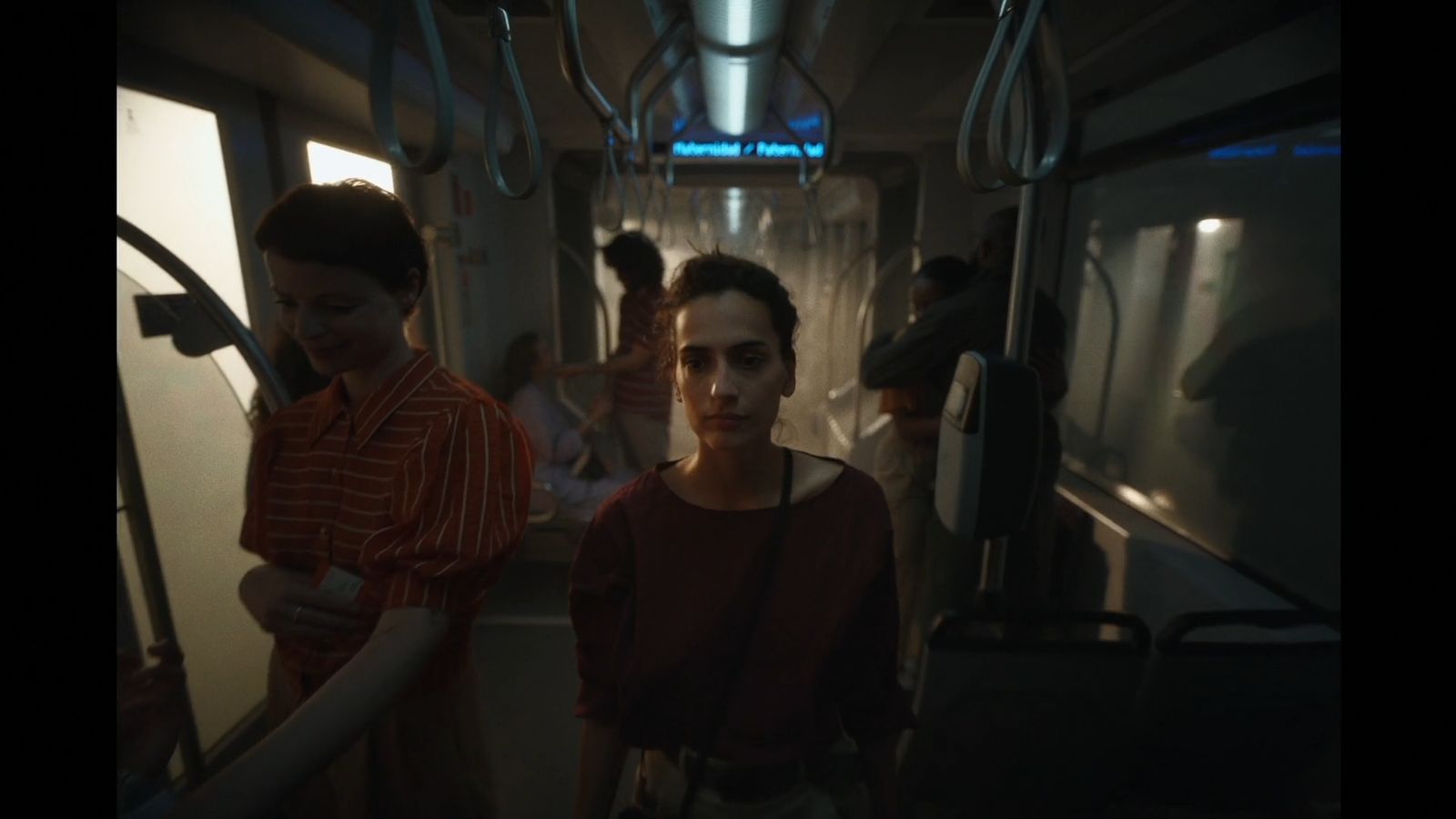 a group of people standing on a subway car