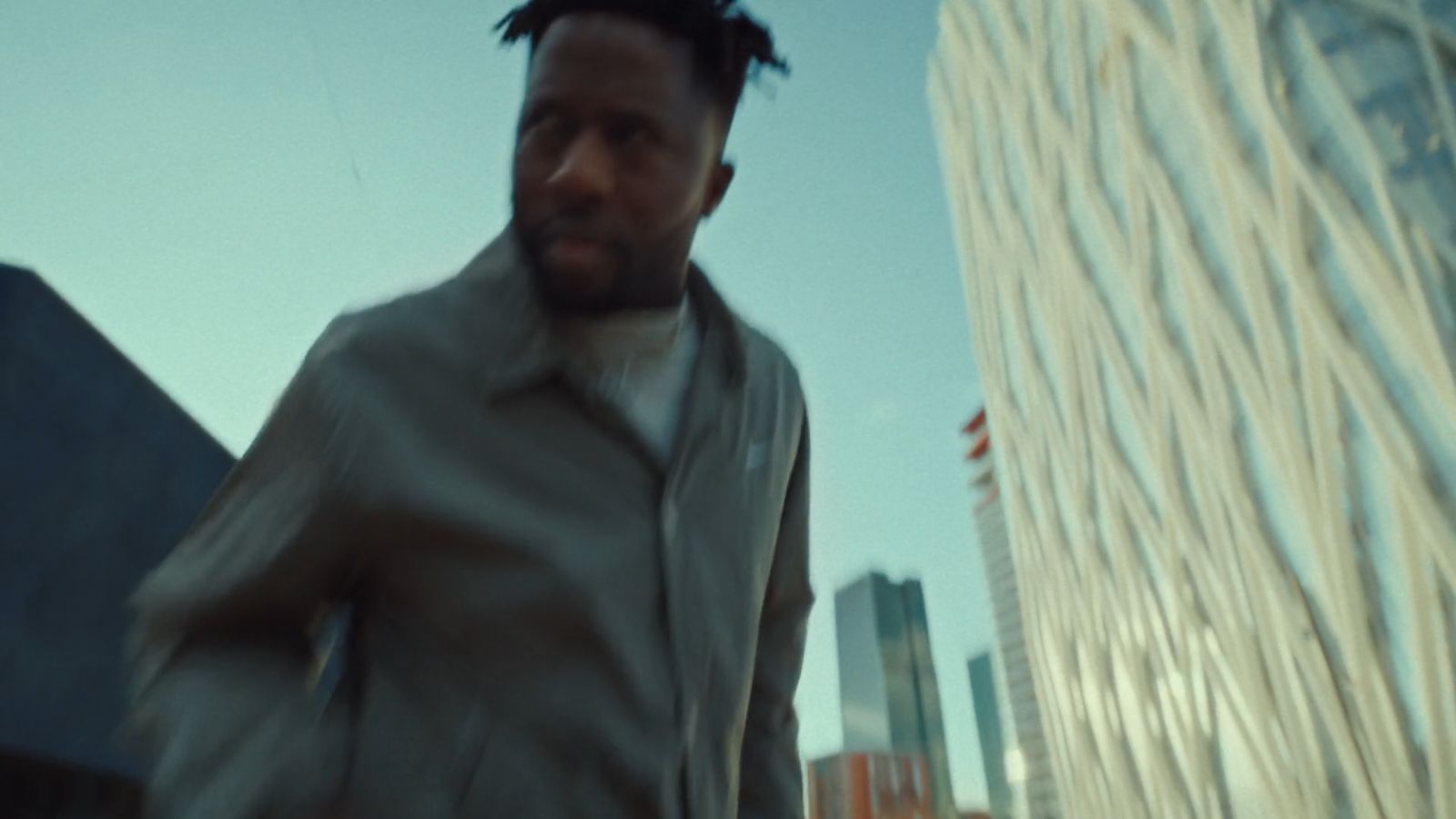 a man standing in front of a tall building