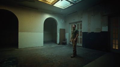 a man standing in a room with a skylight