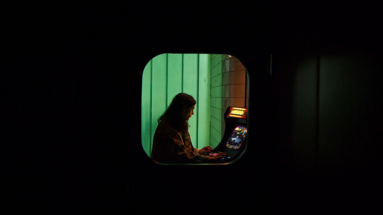 a woman sitting in front of a machine in a dark room