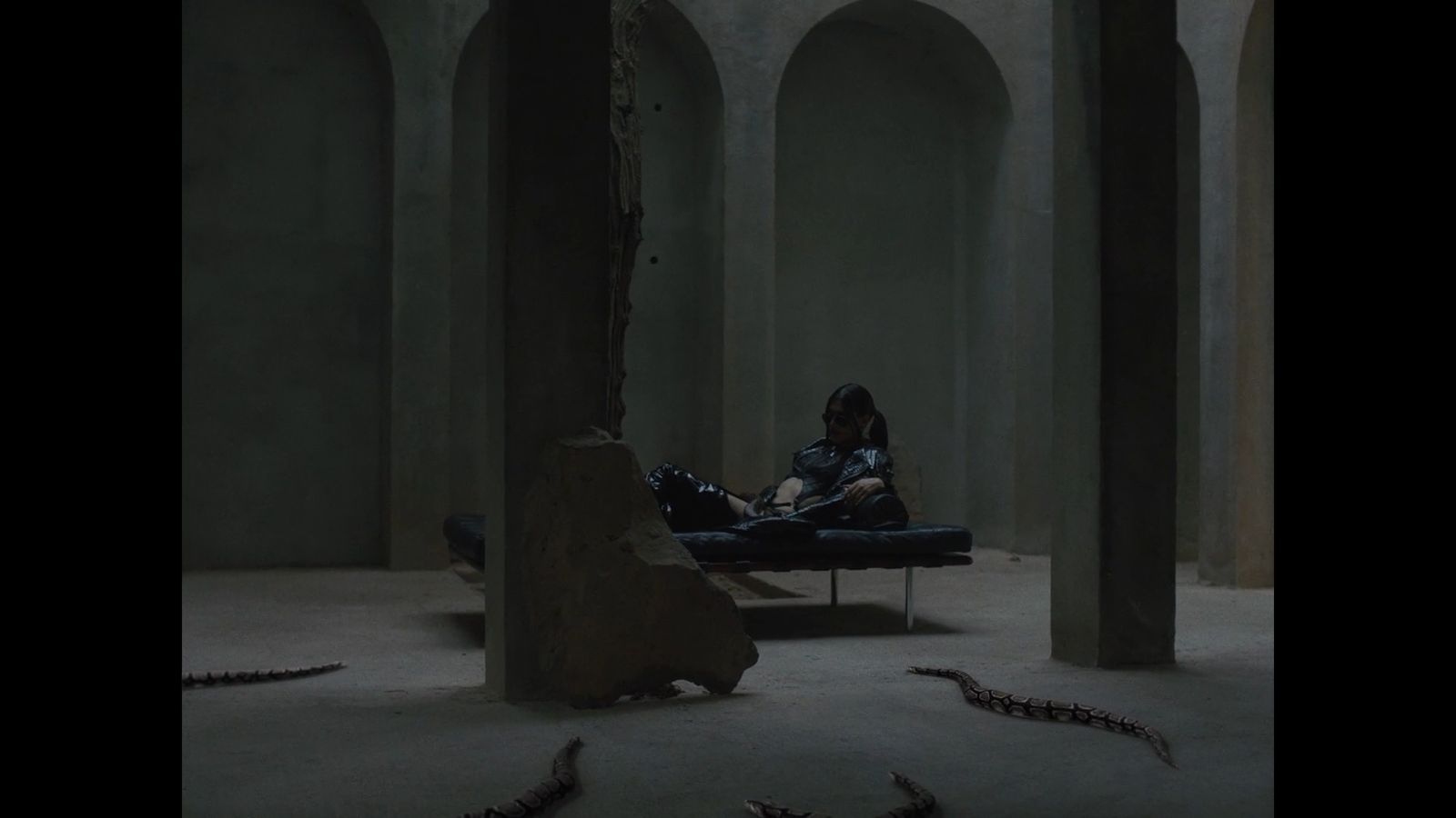 a man sitting on a couch in a dark room