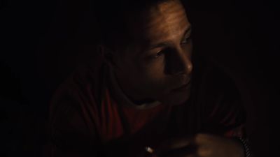 a man holding a cell phone in the dark