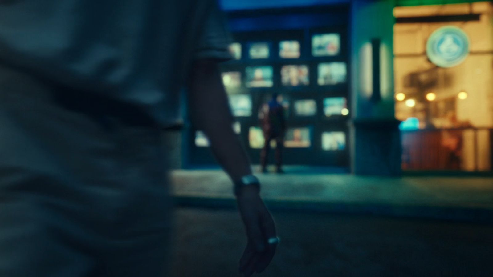 a person walking down a street at night