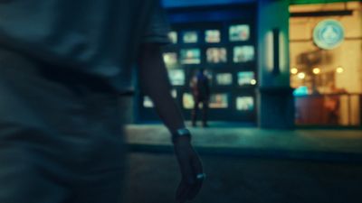 a person walking down a street at night