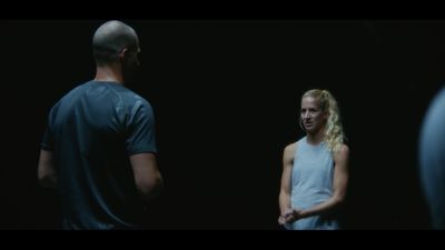 a man standing next to a woman in a dark room