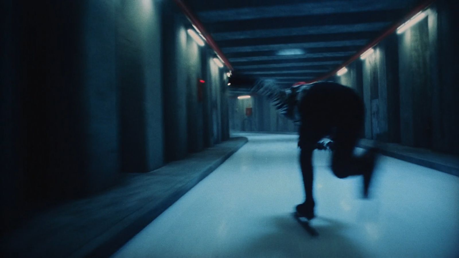 a man riding a skateboard down a hallway