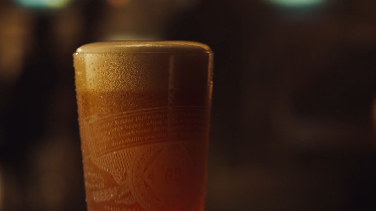 a glass of beer sitting on a table