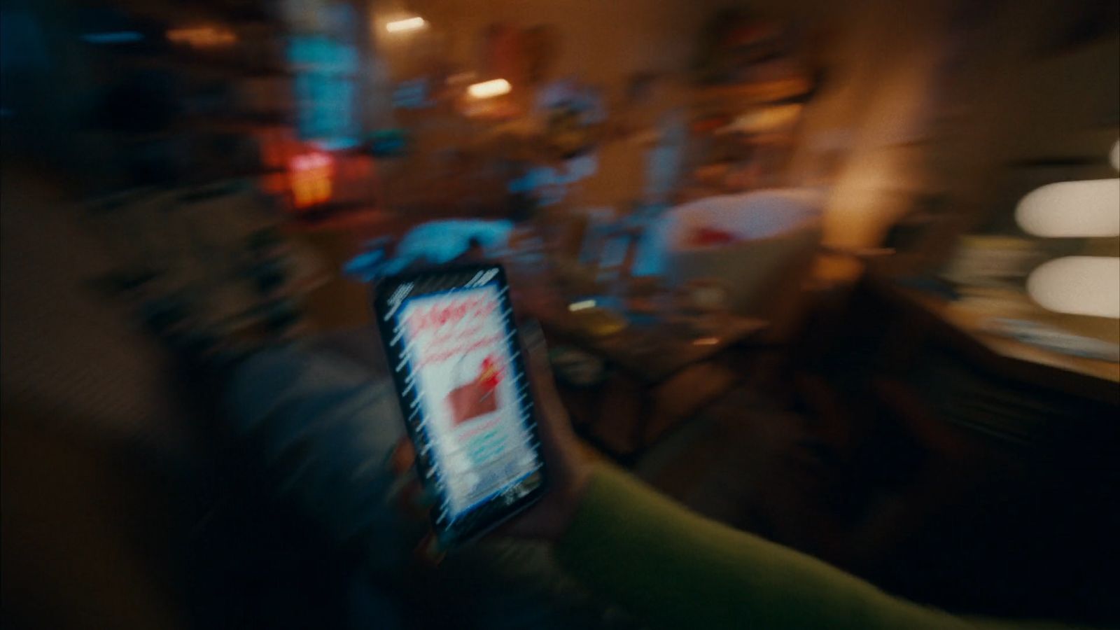 a blurry photo of a person holding a cell phone