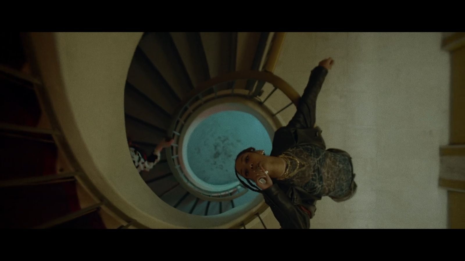 a man standing in front of a spiral staircase