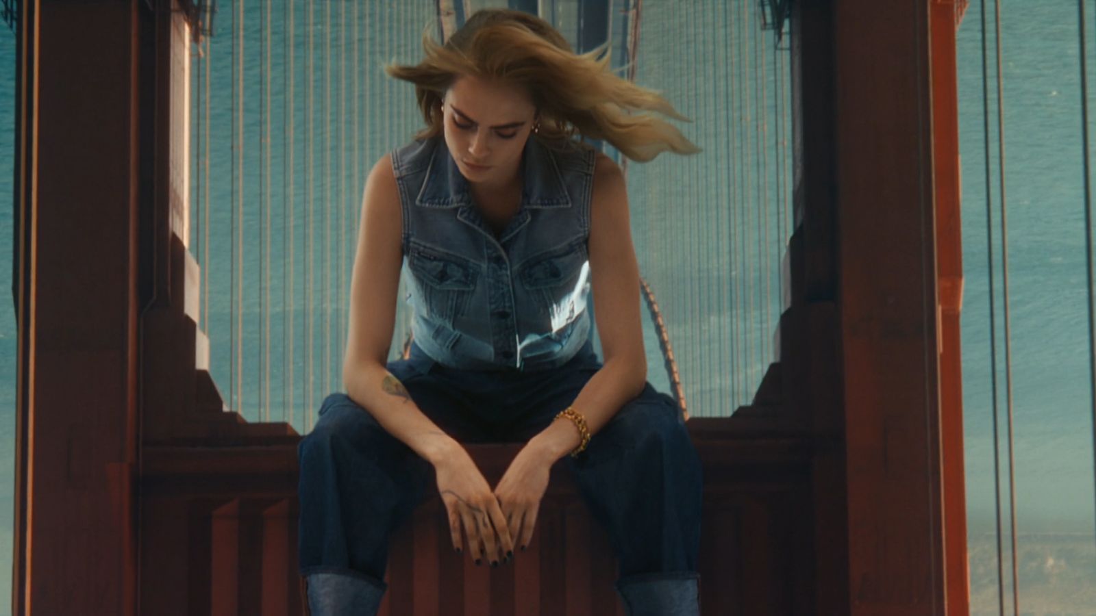 a woman sitting on top of a wooden bench