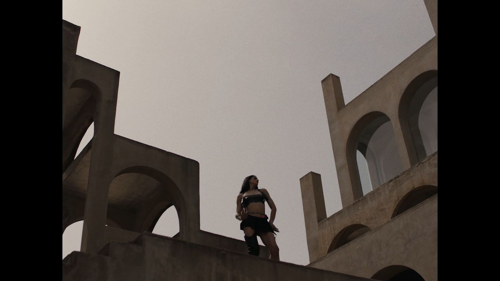 a woman standing on top of a cement structure