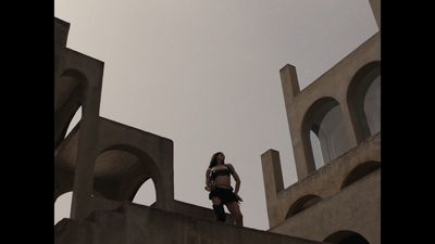 a woman standing on top of a cement structure