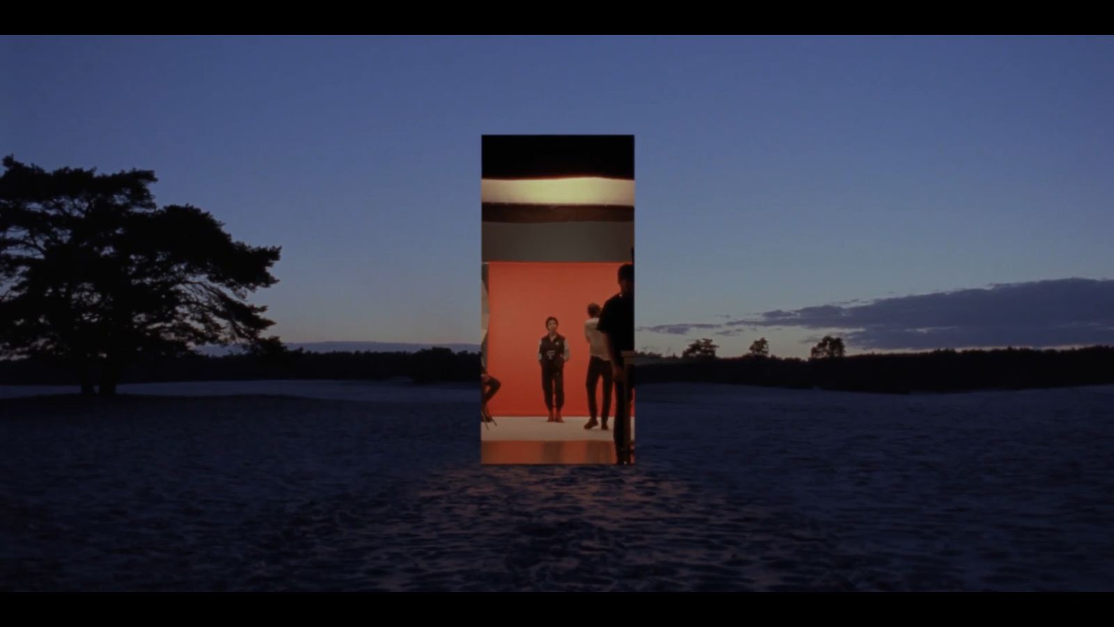 a couple of people standing in front of a door