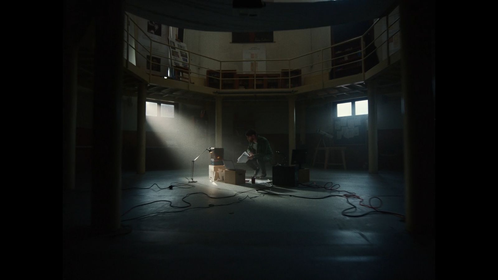 a person standing in a dark room with a microphone