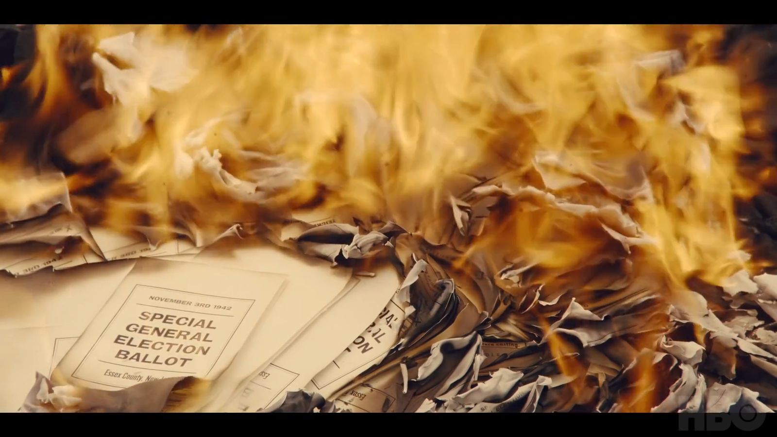 a pile of newspaper sitting on top of a pile of fire