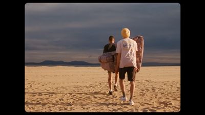 a couple of people that are standing in the sand