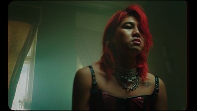 a woman with red hair wearing a choker