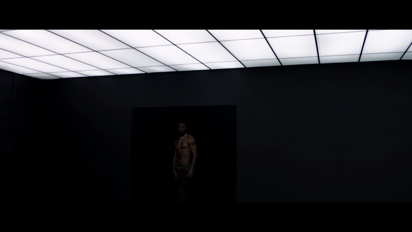 a man is standing in a dark room